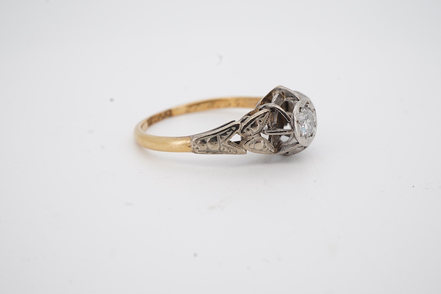 A yellow metal and illusion set single stone diamond ring, stamped 18ct & plat, size M, gross weight 2.3 grams.